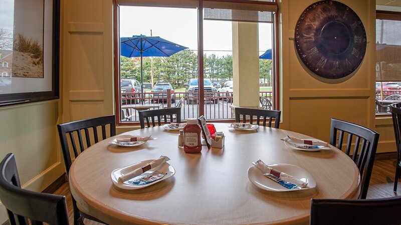 Side dining room with table set for six with view of the outside